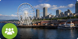 Ferris wheel by waterfront cityscape